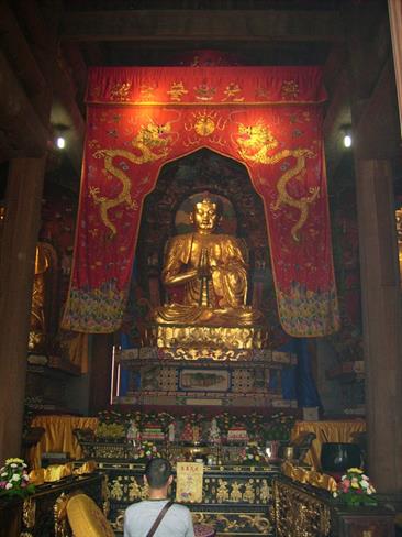Okrog Budovega kipa se lahko popotnik ustavi v številnih svetiščih in prižge paličico kadila. (foto: A.P.)